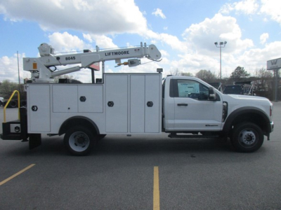 Ford F-550 service body truck with Liftmoore crane, side view showing utility compartments and crane boom labeled Liftmoore 8045.
