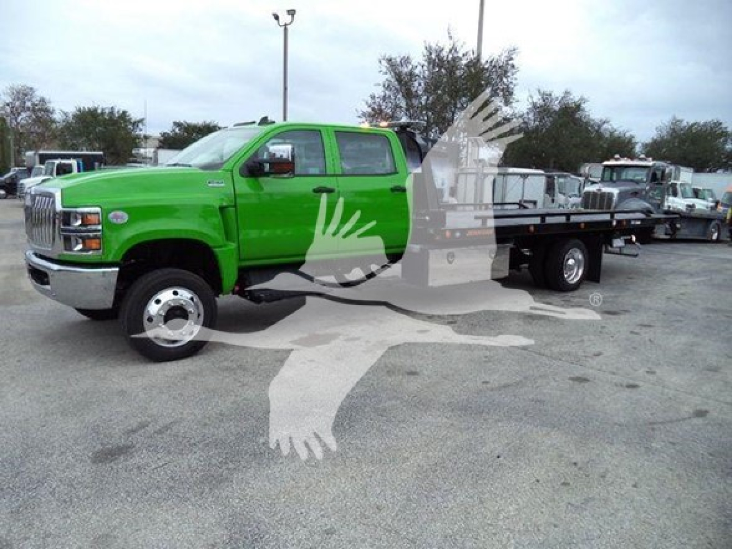 Green 2023 International CV Series truck with flatbed rollback, VIN 1HTKTSWK0PH419811, stock J19811, new vehicle.