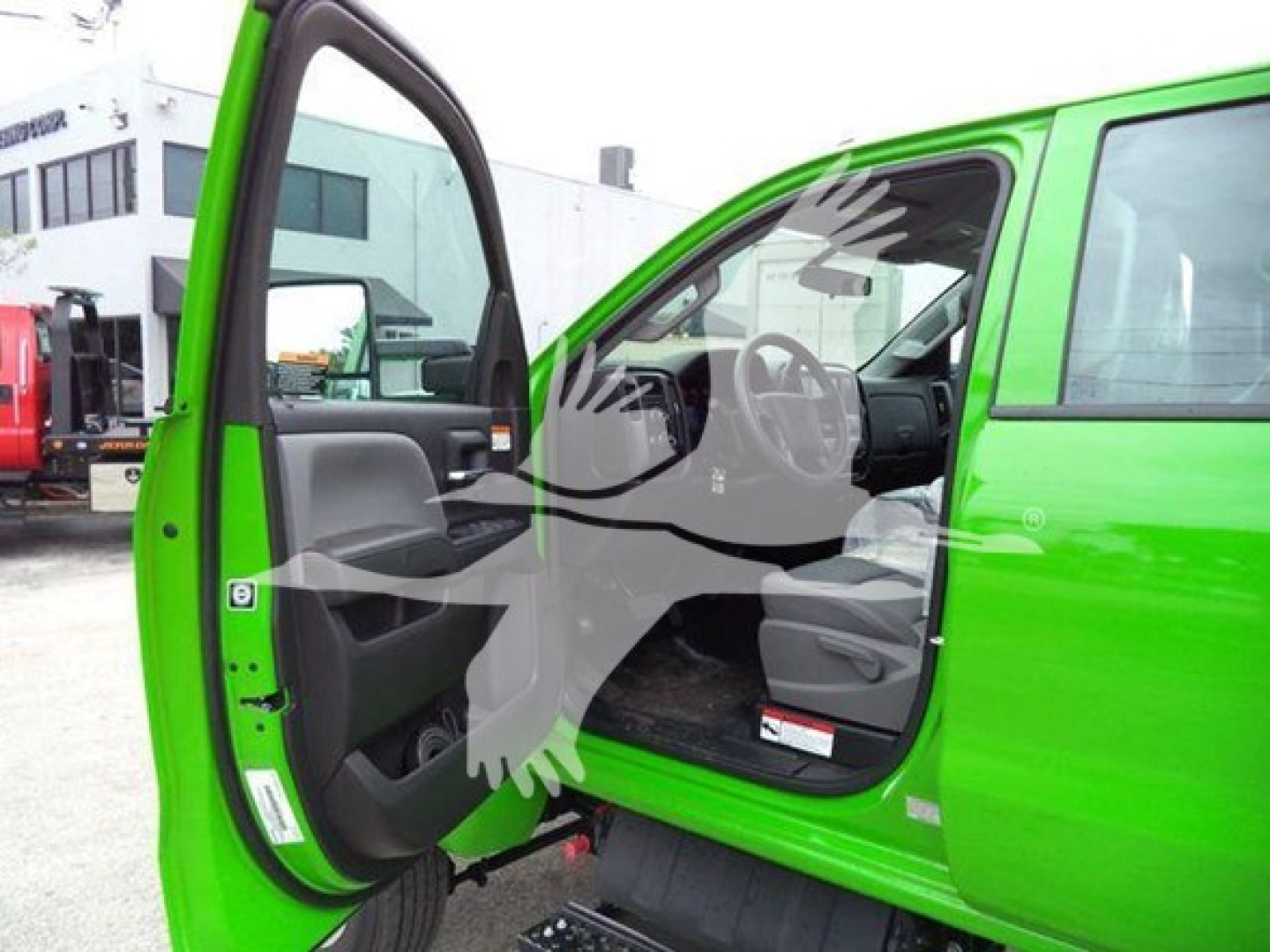 Green 2023 International CV rollback truck interior view with front door open showing driver seat and dashboard.