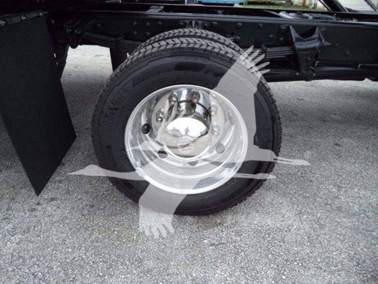 Wheel and tire assembly of a 2023 International CV rollback truck showing silver steel wheel and treaded tire.