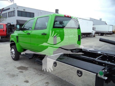 Green 2023 International CV rollback truck side view showing cab and chassis, VIN 1HTKTSWK0PH419811 visible in listing text overlay.