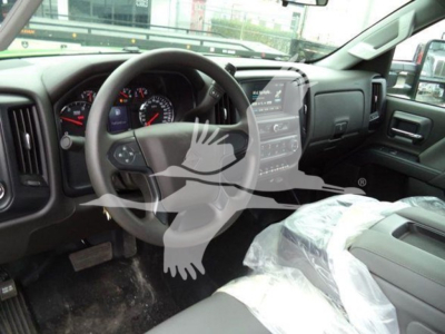 Interior of 2023 International CV truck cockpit showing steering wheel, gauge cluster, and center touchscreen display.