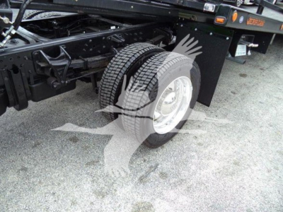 Truck chassis and dual rear wheels of a new 2023 International CV rollback truck showing tire and wheel assembly.