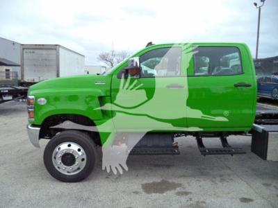 Truck side view showing bright green International CV with large white graphic overlaid on cab and doors; no legible small text visible on image.