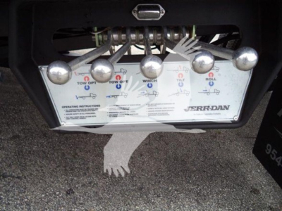 Control panel with levers and labels for a Jerr-Dan tow system mounted on a truck. Visible text includes 'JERR-DAN' and various operation instructions for tow options.