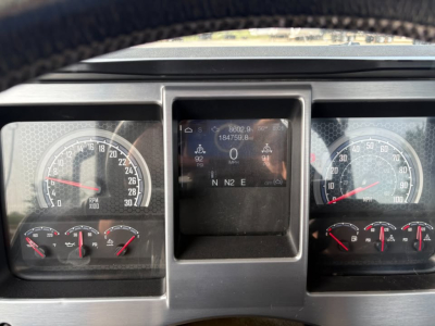 Dash gauges and central display of a 2019 Mack ANTHEM truck showing analog speedometer and tachometer, with digital readout in center.