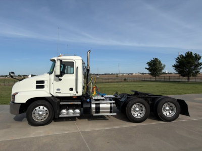 Tractor unit in profile view showing white 2019 Mack Anthem day cab with chassis and rear dual-axle configuration.
