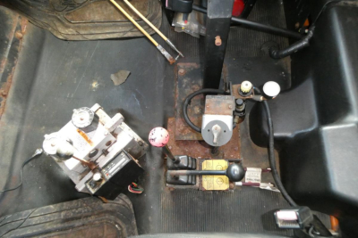 Trucks equipment compartment showing control valves and hydraulic components with labels and cables.