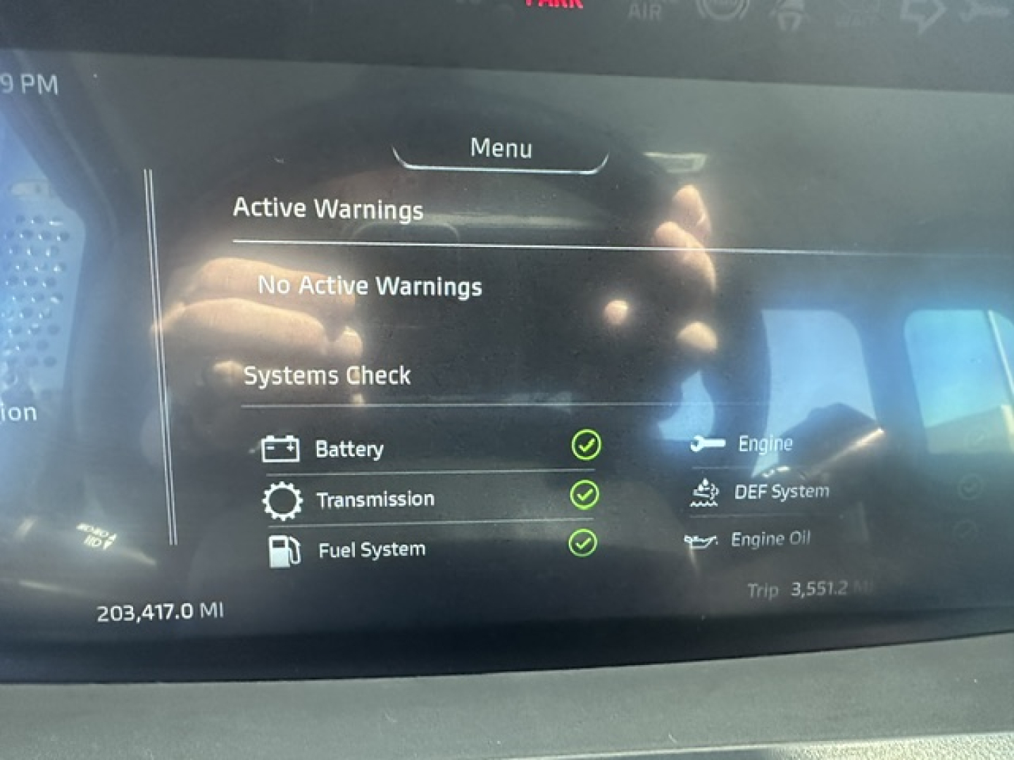 Dashboard screen of a Kenworth truck showing Vehicle Diagnostics: Battery, Transmission, Fuel System checks with green status icons; mileage 203,417.0 MI.