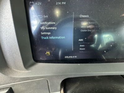 Dashboard display in a Kenworth T880 showing truck information and trip summary with menus visible on screen
