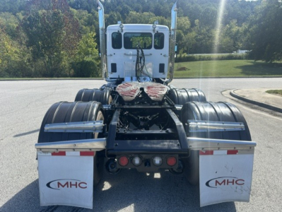 Kenworth T880 rear view showing fifth wheel and dual rear axles with MHC mud flaps.