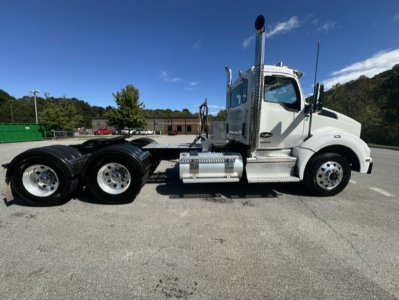 Kenworth T880 Conventional Daycab tractor truck side view showing cab, chrome fuel tanks, and dual rear axles.