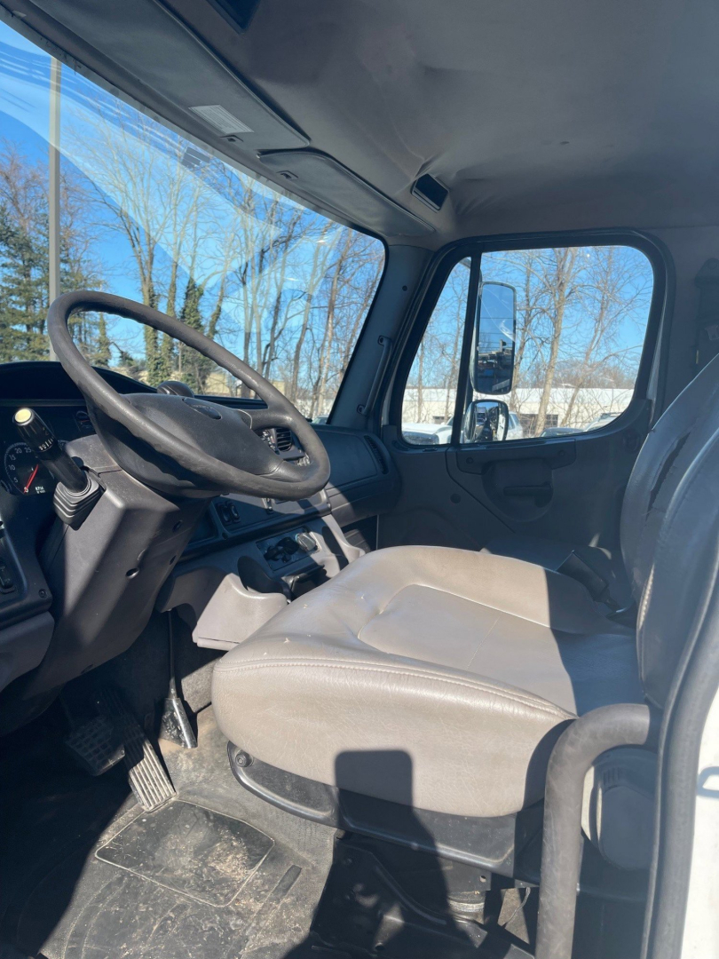 Cab interior of a 2019 Freightliner M2 106 Tow Truck showing steering wheel, driver seat, and dashboard.