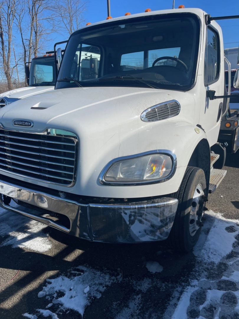 Front-left view of a white 2019 Freightliner M2 106 medium duty tow truck showing cab and chrome bumper, grille, and headlight clusters.