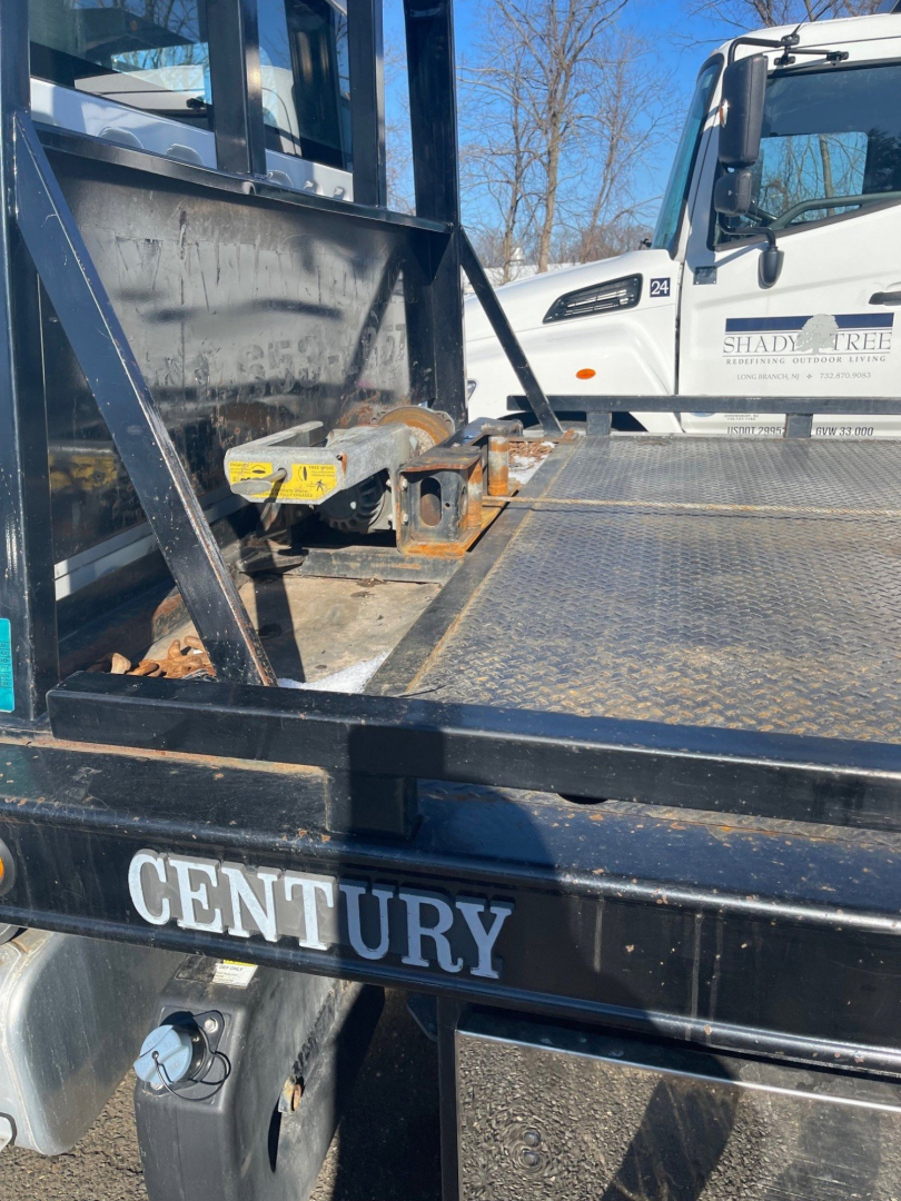 Freightliner M2 106 tow truck bed area showing Century Equipment branding and wheel setup.