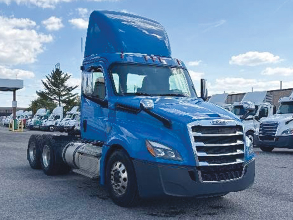 Freightliner Cascadia 116 sleeper cab tractor in blue, side view showing front grille, headlights, and dual rear axles.