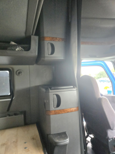 Cab interior showing storage compartments and seating area of a 2021 International LT625 truck sleeper.