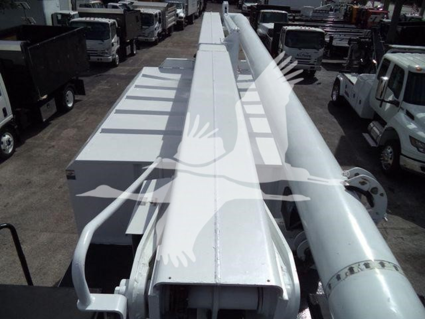 Ford bucket truck crane arm in white with ladder-like sections and hydraulic boom structure, viewed from above.
