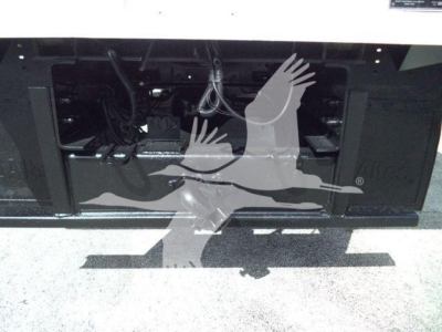 Ford F750 bucket truck front chassis view showing engine bay with various wires and components exposed.