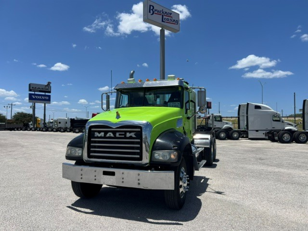 Mack GR64FT truck front view showing bright green cab and chrome bumper.