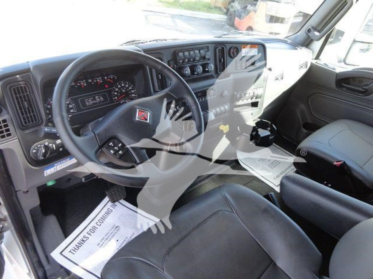 Truck cab interior showing steering wheel, dashboard, and front seats in a new 2027 International MV listing.