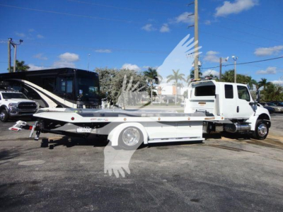 Flatbed tow truck from side view with a white cab and extended chrome bed, International MV line, stock STEPSIDEMV607