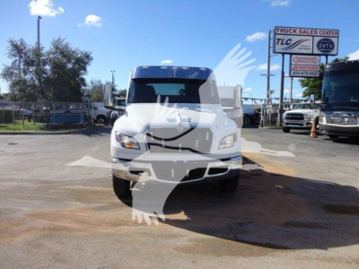 Truck front view in dealership lot showing white cab International MV with centered grille and headlights.