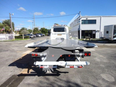 Truck rear view of a new International MV rollback truck showing the towing platform and lights.