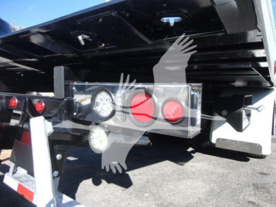 Back of a new 2027 International MV rollback truck showing rear lights, bumper, and hydraulic components with a logo watermark overlaid.