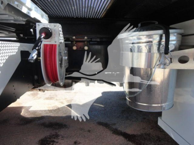 Truck chassis showing hydraulic hose reel and fuel tank undercarriage portion of a 2027 International MV rollback truck.