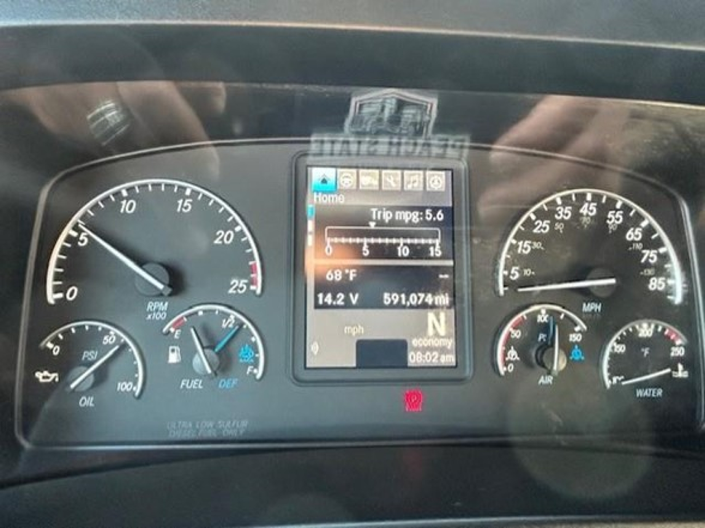 Dashboard of a Freightliner Cascadia 126 truck showing gauge cluster, central digital display, and multiple dials.
