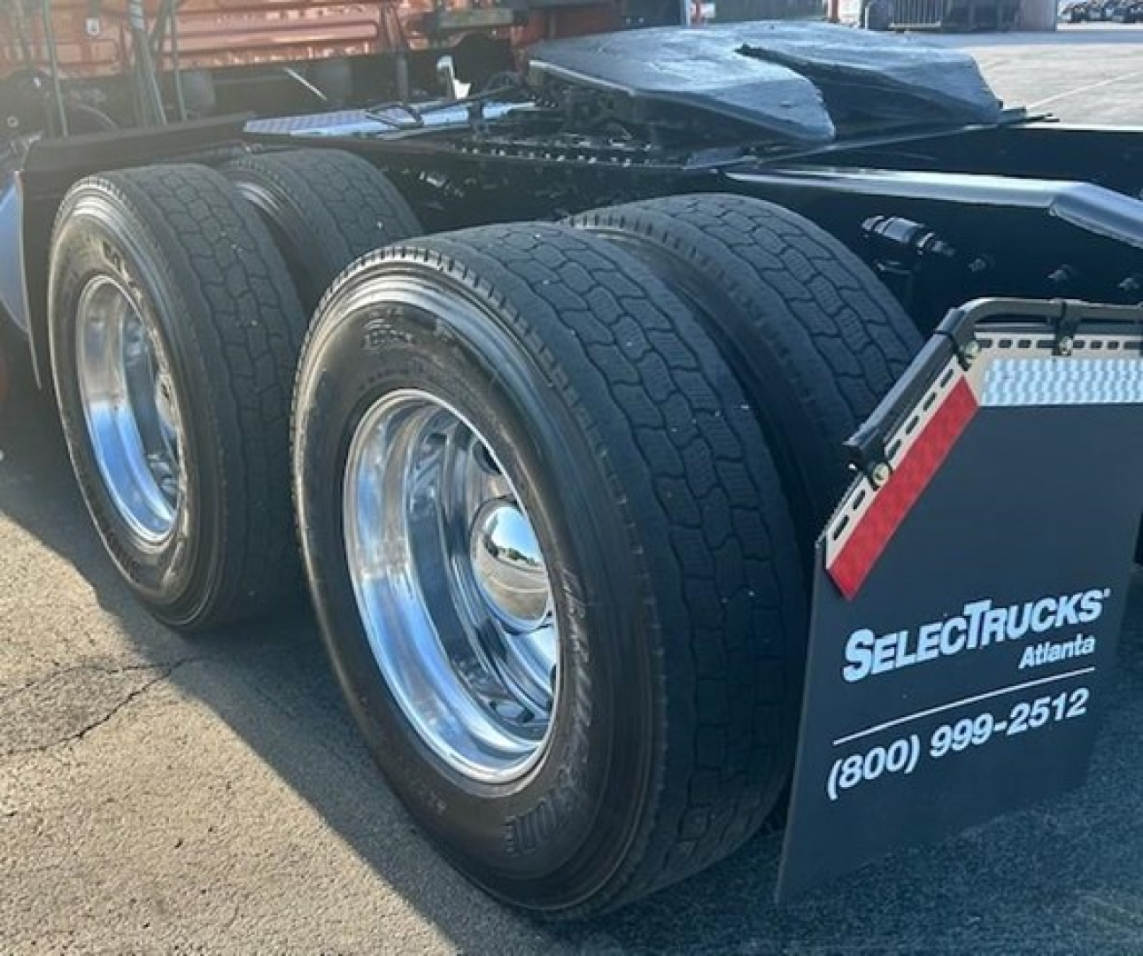 Freightliner Cascadia 126 rear axles and wheel set showing dual tires with chrome rims in service condition.