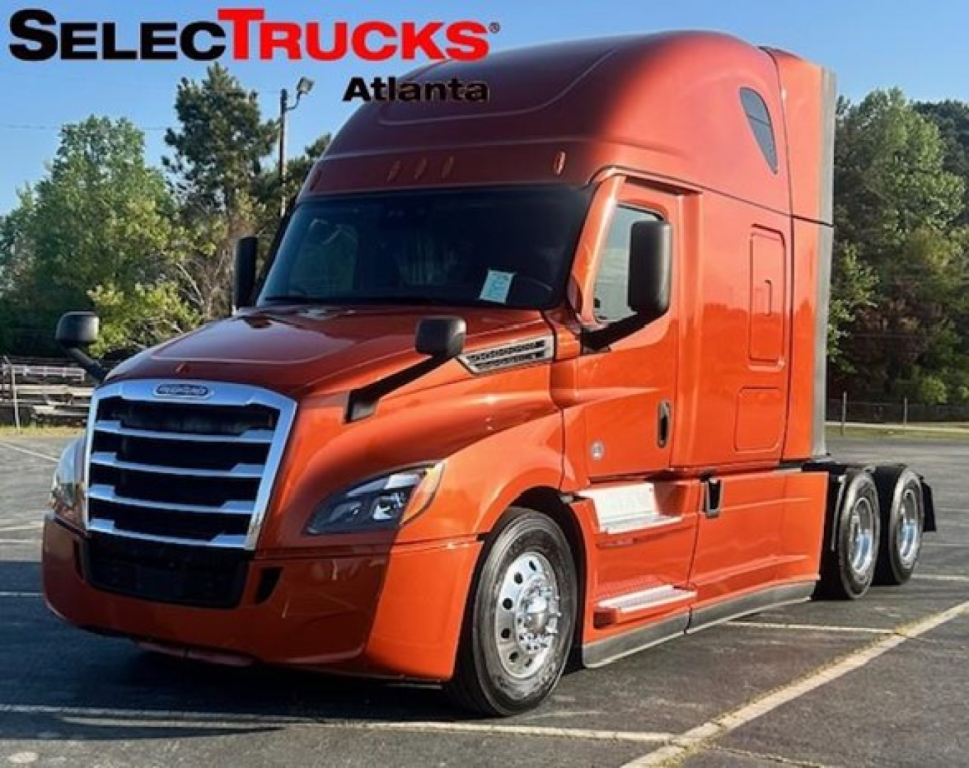 Freightliner Cascadia 126 sleeper cab tractor in orange, front-left view.