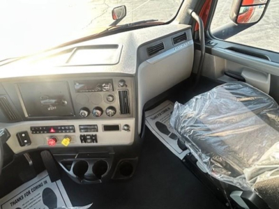 Freightliner Cascadia 126 truck interior showing dashboard controls and a plastic-covered seat.