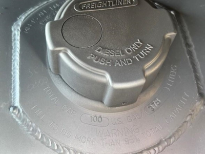 Freightliner fuel cap with text: DIESEL ONLY PUSH AND TURN, TOTAL CAP, 100, U.S. GAL, WARNING, INSTALL NO. 0 MORE THAN 99.9 TOTAL CAPACITY, 3/8 INCH? markings around cap.