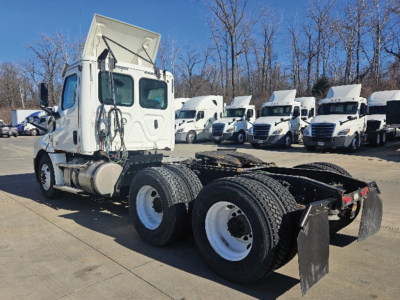 Truck chassis and cab of a 2020 Freightliner Cascadia126 tractor viewed from side front-left, with multiple similar tractors in background.