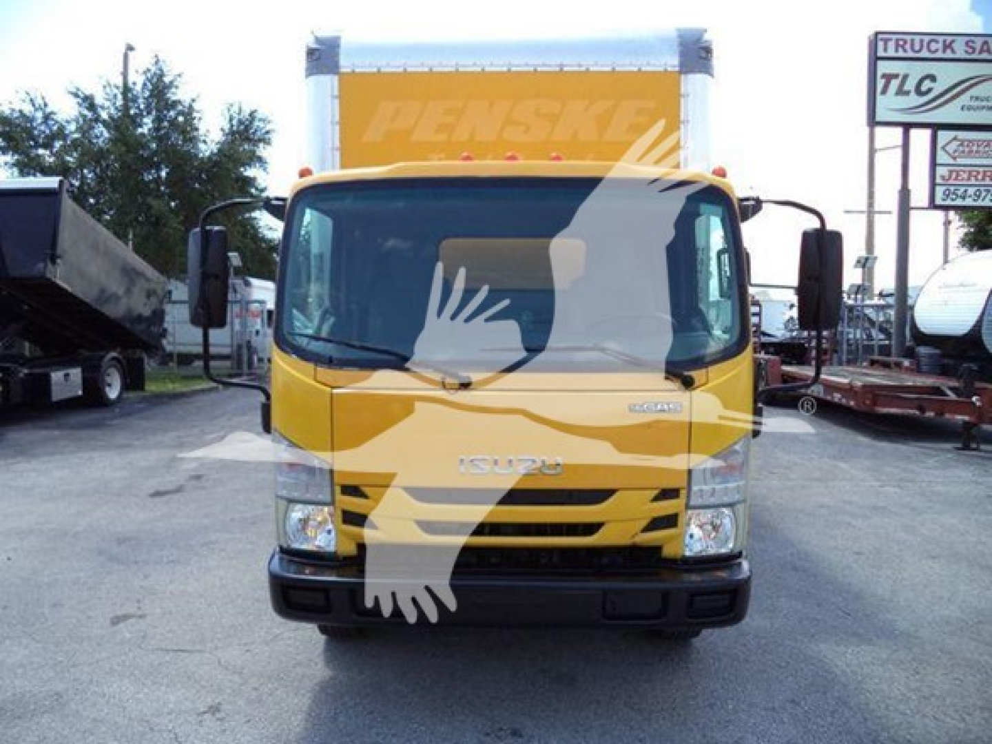 Isuzu NPR HD truck front view in yellow with Penske box, daytime outdoor lot.