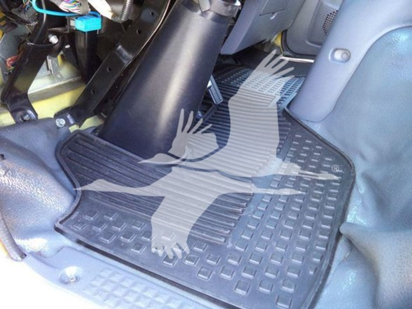 Isuzu NPR HD interior floor area showing rubber mat and pedals with wiring harnesses visible