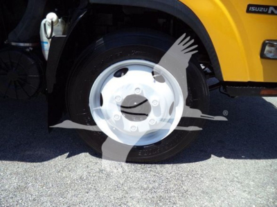 Isuzu NPR truck front wheel and fender view showing wheel and part of yellow body with Isuzu badge.