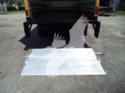 Isuzu NPR HD box truck rear with aluminum ramp deployed from tailgate area.