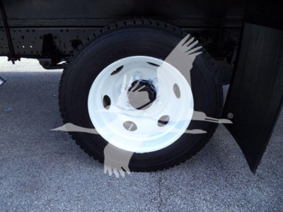 Isuzu NPR HD wheel shown under truck with white steel rim and black tire; no visible text other than wheel and body shadows.