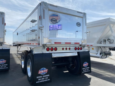 Dump trailer rear view showing MAC dump trailer with dual rear axles and mudflaps with Utility Colorado logo