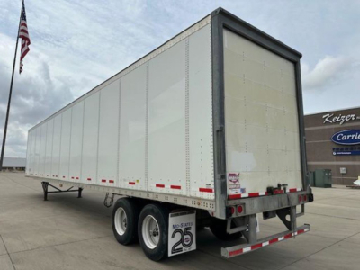 Trailer side and rear view of a 2016 Wabash van trailer with dual rear axles, white aluminum panels, and reflective tape.