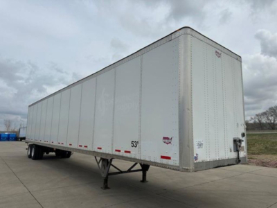 Trailer: 53' Wabash van semi-trailer seen from front-right corner, white exterior, dual rear axles, landing gear visible, no cab attached.