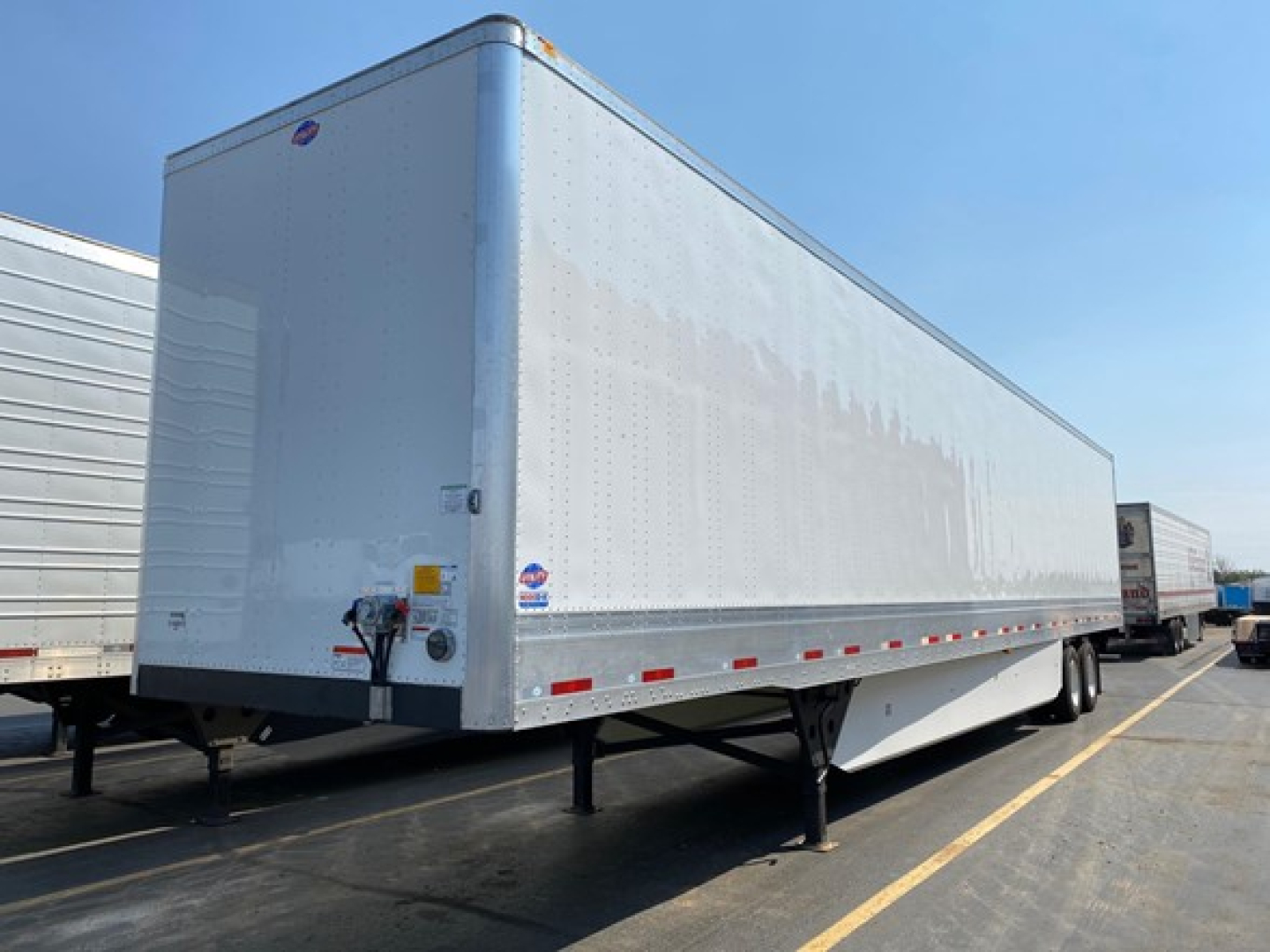 Utility 4000dx trailer undercarriage and side panel showing aluminum exterior and support legs.
