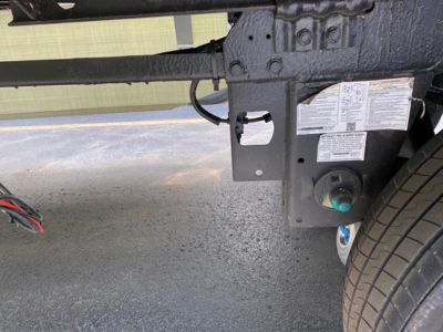Trailer hitch area of a 2027 Utility 4000Dx Tbr trailer showing frame, landing gear, and VIN sticker details.