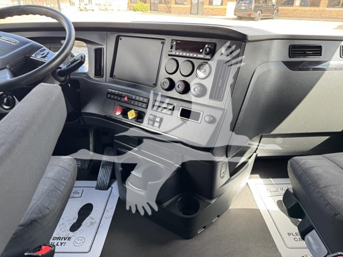 Dashboard interior of 2023 Freightliner Cascadia 126 truck showing steering wheel, center console with gauges, touchscreen display, and gear shifter area.
