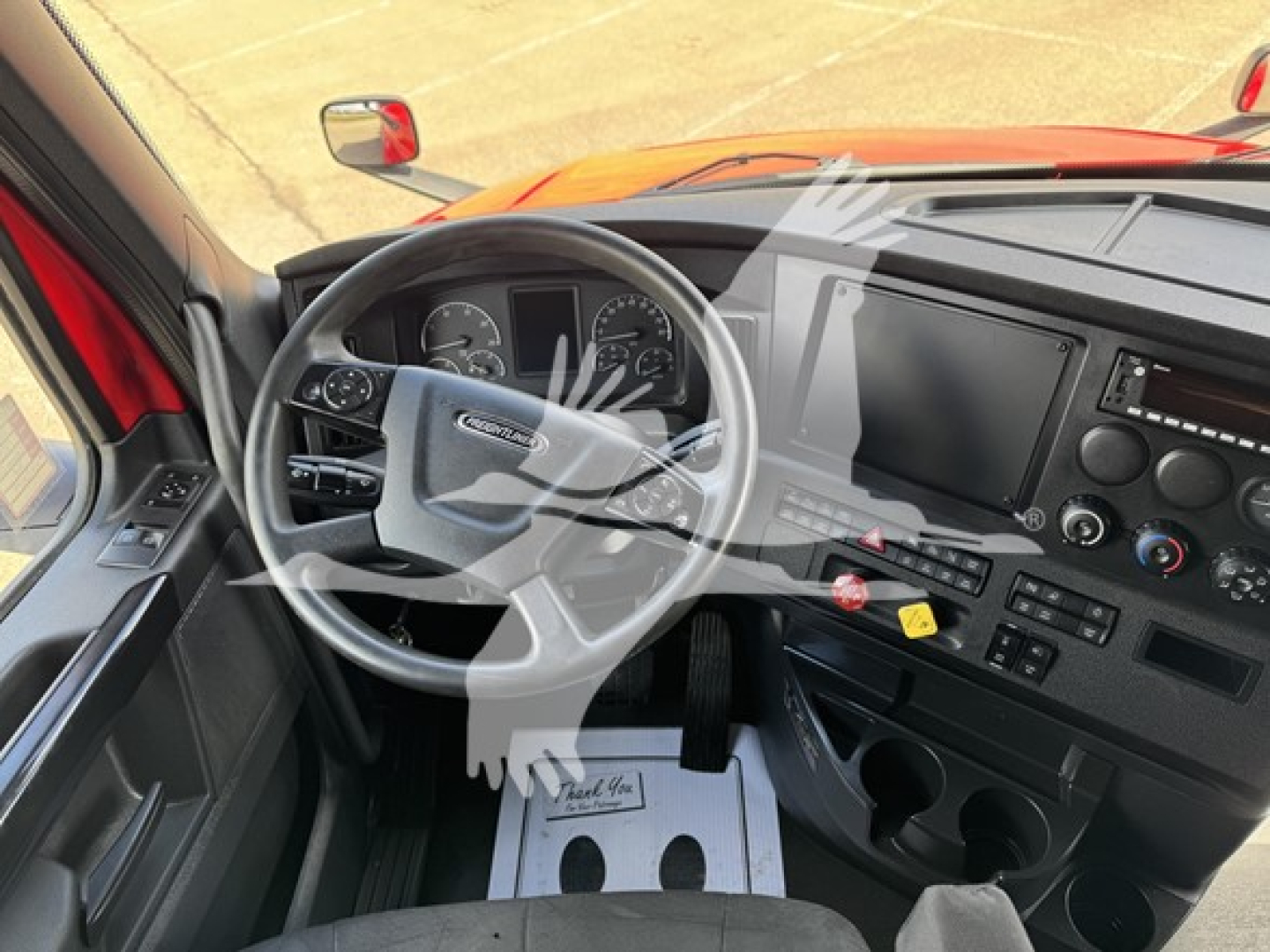 Freightliner Cascadia truck interior/dashboard with steering wheel, gauges, center console, and driver-side view.