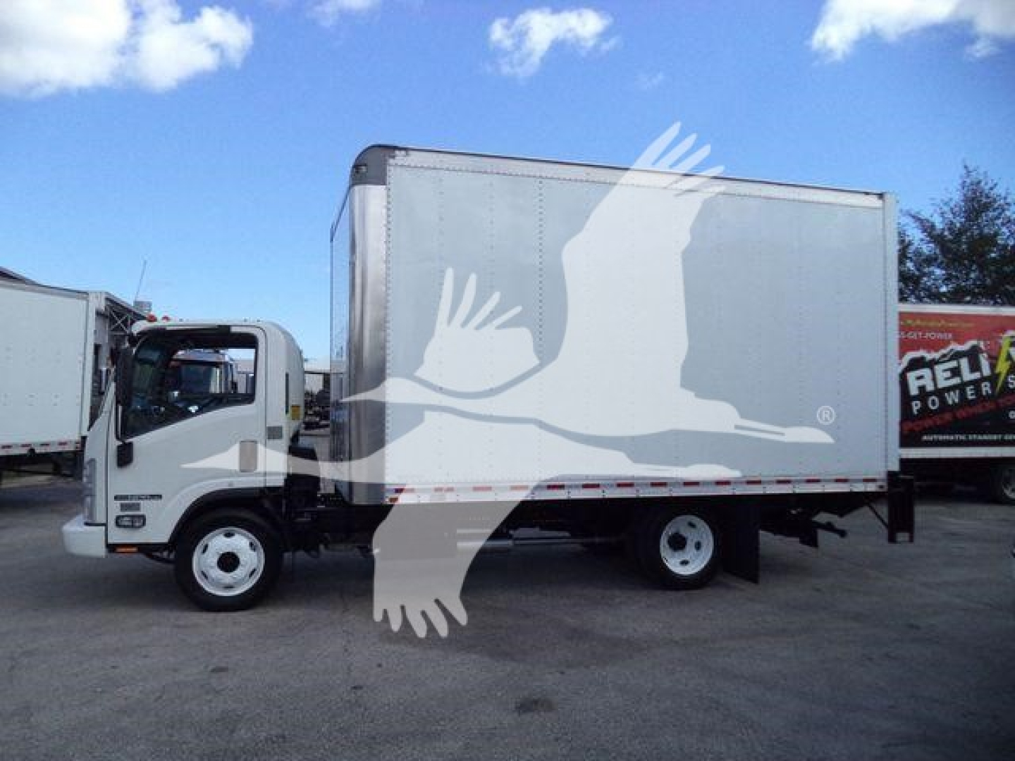 Isuzu NPR HD box truck side view showing cargo box and cab, white vehicle with silver box, logo watermark overlay from site.