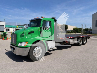 Green Kenworth T370 rollback truck with extended flatbed and chrome front bumper, side view showing cab and dual rear axles.
